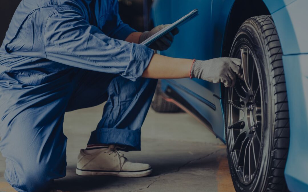 A photo witha background of car specialists repairing a car